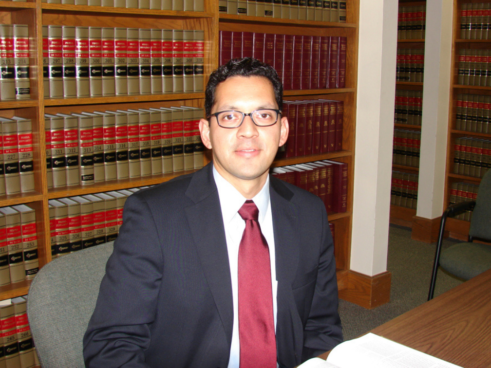 Attorney Genaro Retta Cortez reviewing case law in the San Antonio Bar Association library.